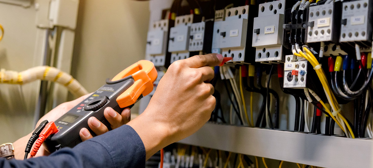 Electrical Services Technician Working on Fuse Box